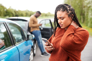 a woman on her phone after a car accident in Marietta, GA