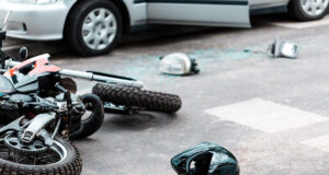 a damaged motorcycle and helmet on the road in Snellville, GA