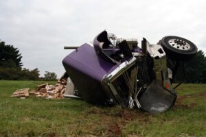 a damaged truck on its side in a field in Duluth, GA